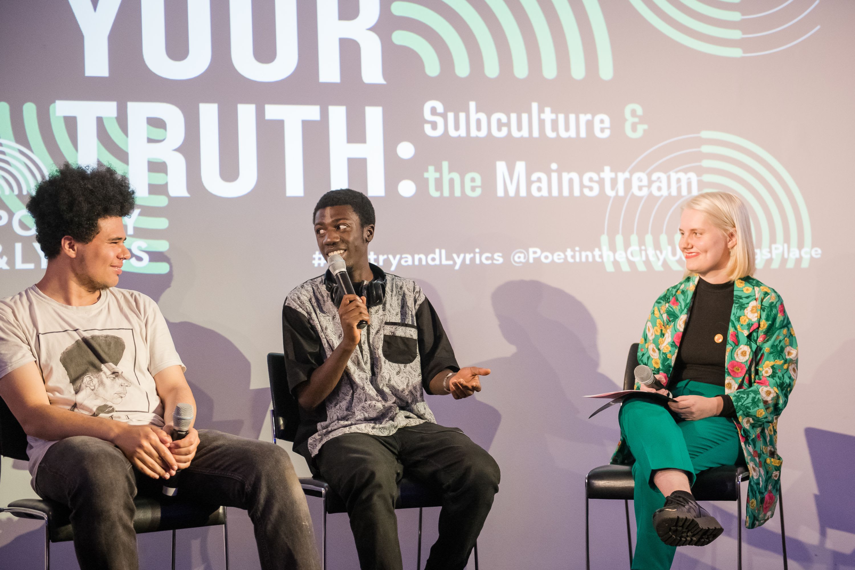 Otis Mensah, The Repeat Beat Poet, and Billie Manning on stage at Speak Your Truth